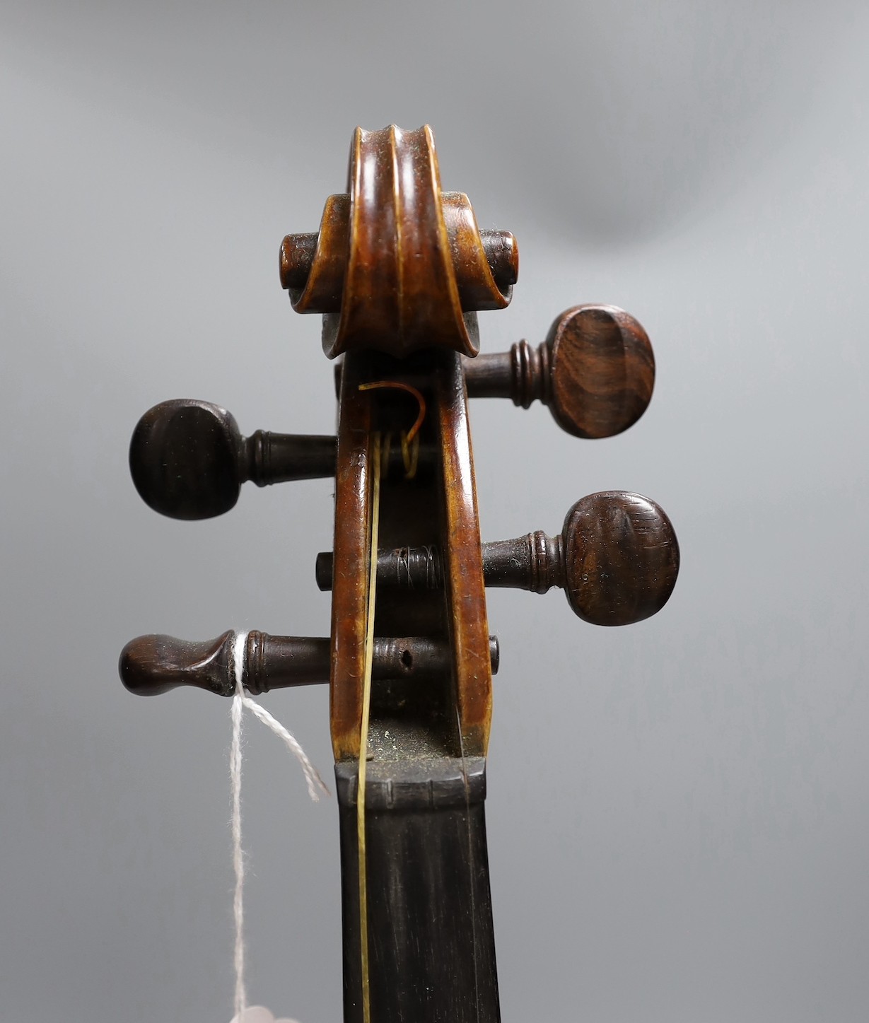 A cased late 19th century English violin, inscribed W. Heaton maker 1887 (?), back measures 35.5cm excl button